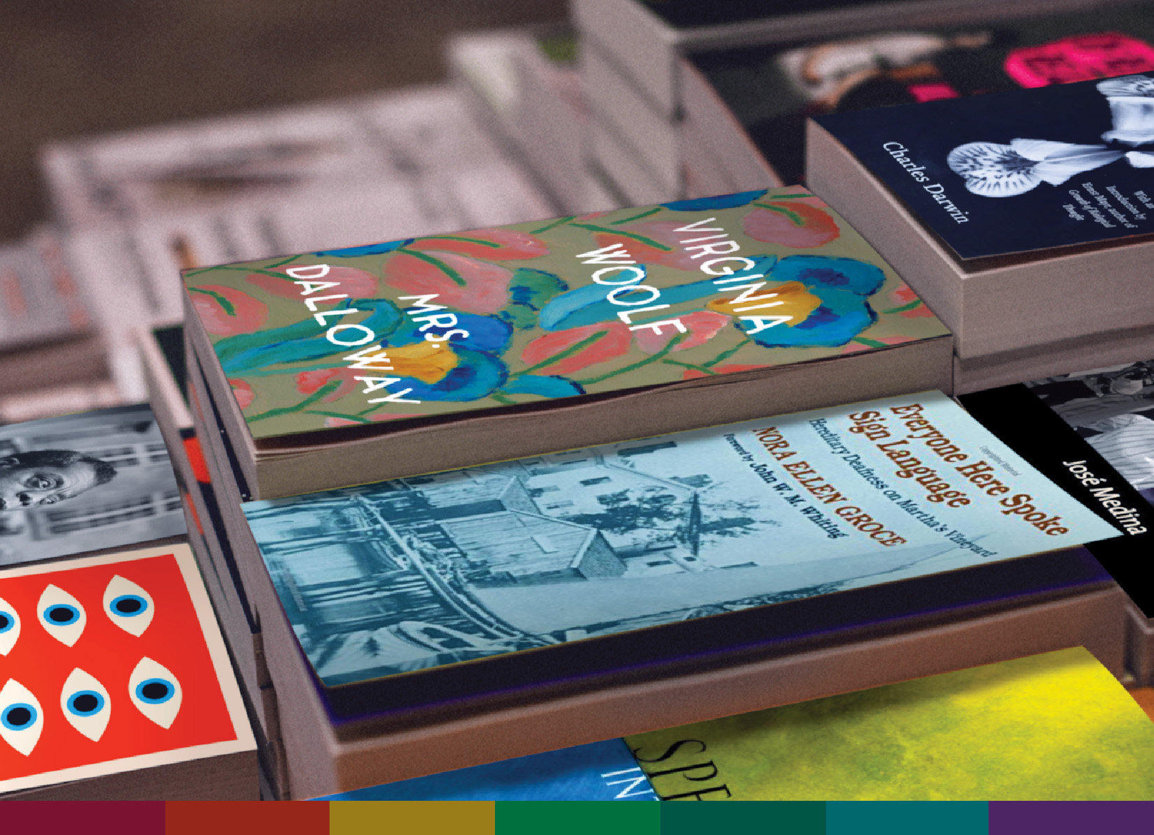 A copy of Virginia Woolf's "Mrs. Dalloway" and other featured books sit on a table. 