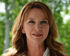 Headshot of Christine smiling at the camera